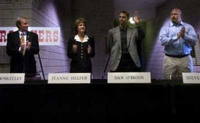 
John Roskelley, far left, Jeanne Eggart Helfer and Steve Emtman, far right, applaud as Dan O'Brien waves to the crowd at the Arena. 
 (Ingrid Barrentine / The Spokesman-Review)