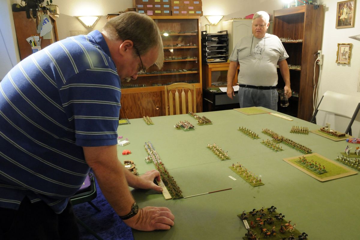 John Meyer, left, and Terry Griner set up a gameboard with miniatures to play a fictional skirmish set around 300 B.C. between Kyrene (Cyrene) Greece and Egypt, when Ptolomy, one of Alexander the Great’s successor generals, ruled Egypt. (PHOTOS BY J. BART RAYNIAK)