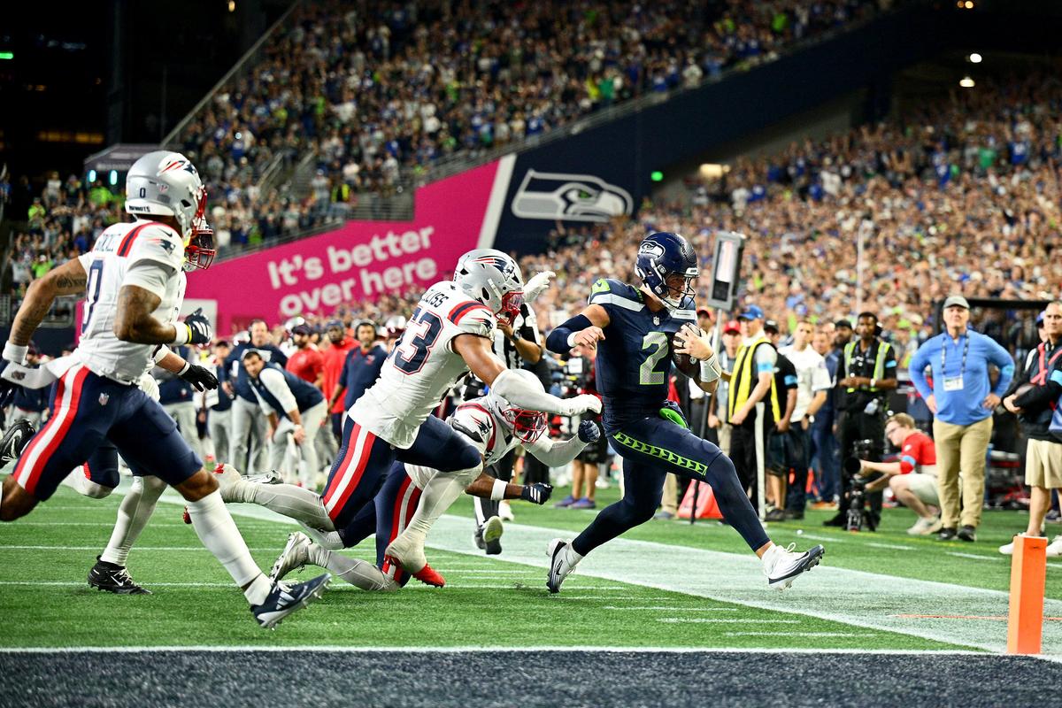 Seattle quarterback Drew Lock runs the ball for a first down against New England at Lumen Field on Wednesday in Seattle. (Getty Images)