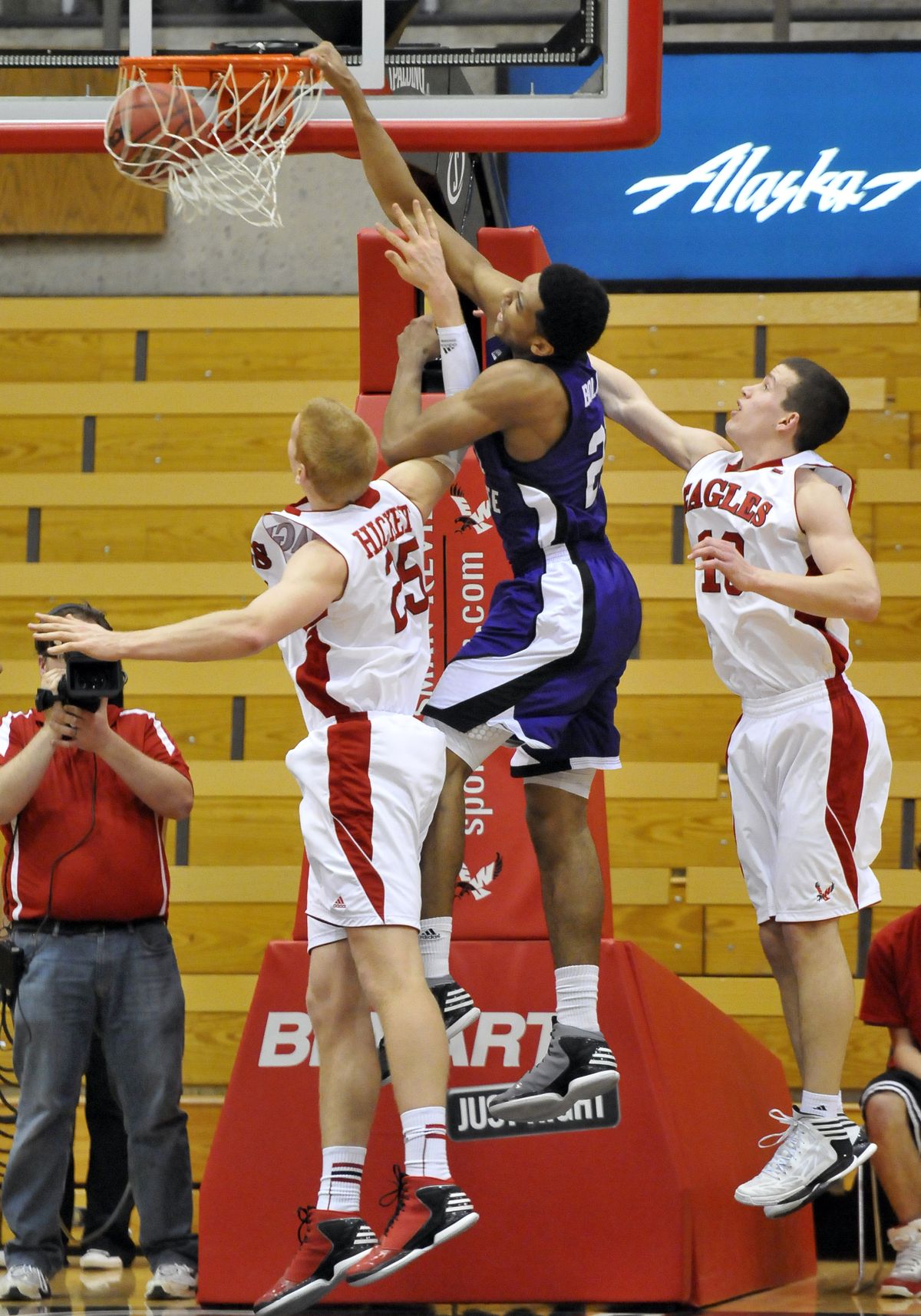 Eagles Jordan Hickert, left, and Parker Kelly can’t stop Weber State’s Joel Bolomboy from slam. (Jesse Tinsley)