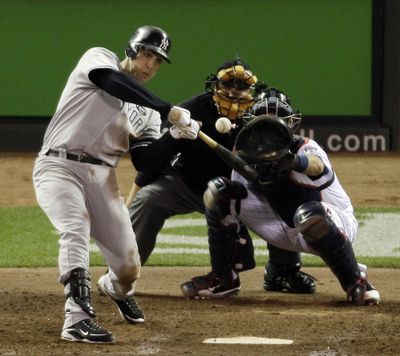 Mark Teixeira of the New York Yankees hits the game-winning two-run homer during the seventh inning.  (Associated Press)