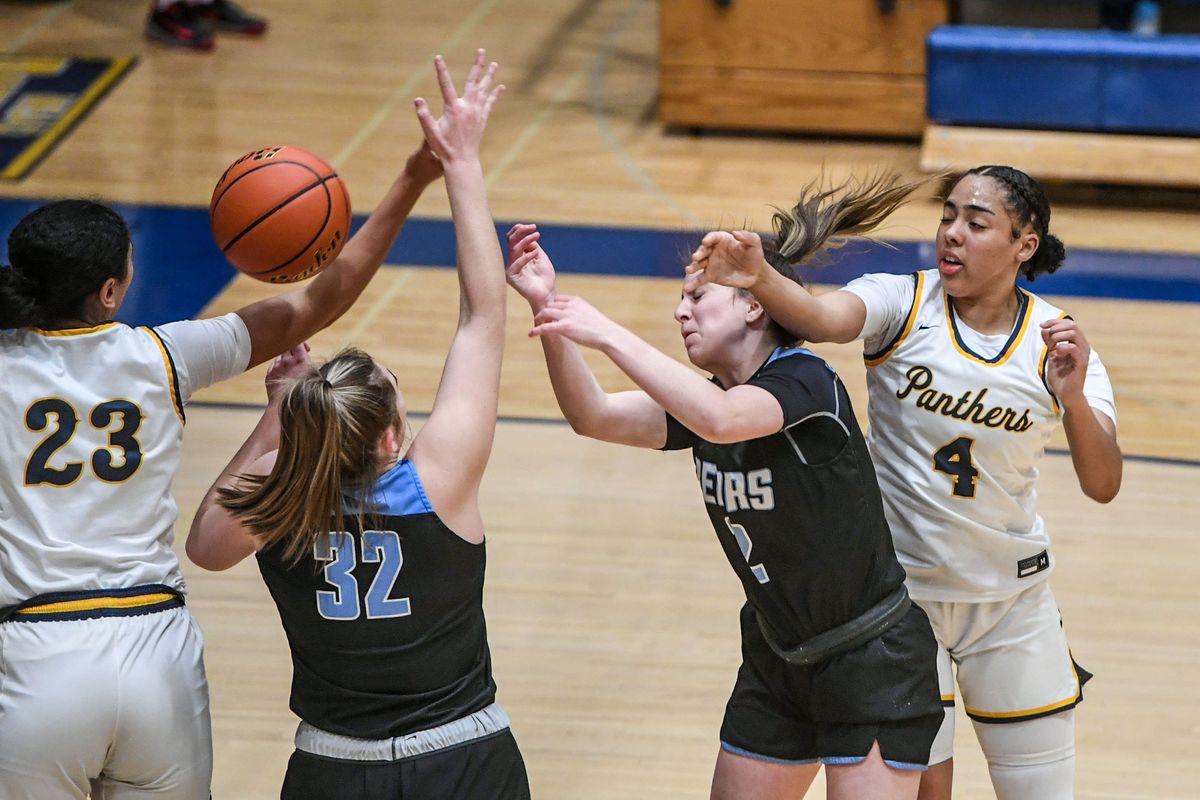 Mead post players Parker Brown (23) and Alicia Suggs battle Central Valley’s Natalie Brown (32) and Makenna Monks for a rebound Tuesday at Mead High School.  (DAN PELLE/THE SPOKESMAN-REVIEW)