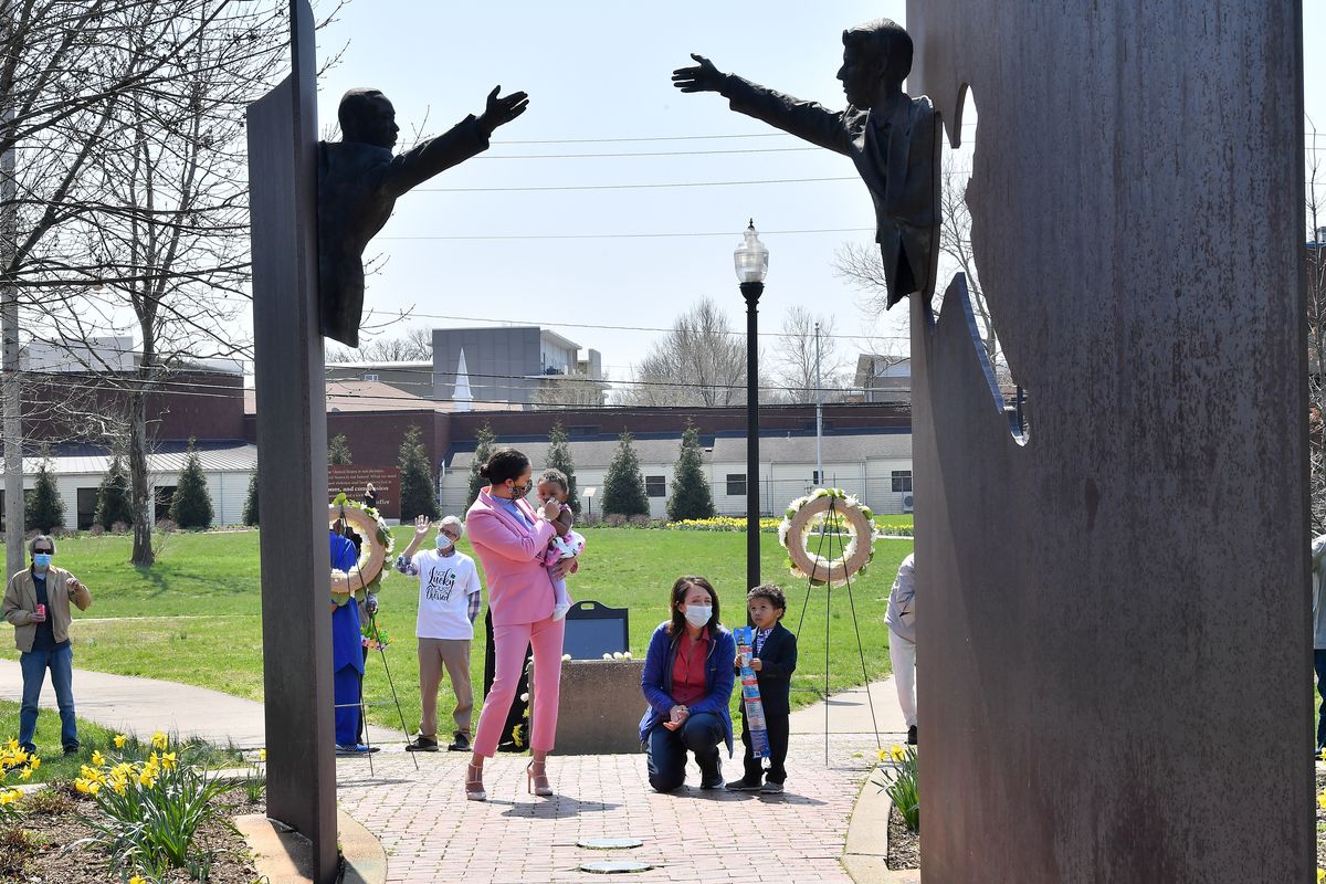 U.S. Sen. Maria Cantwell, D-Wash., center, visits with Landon Lockett, right, his Amanda Washington Lockett, left, who holds his sister, Olivia, at the Landmark for Peace Memorial at Dr. Martin Luther King Jr. Park on Sunday, April 4, 2021, in Indianapolis, Ind.  (Tyler Tjomsland/The Spokesman-Review)