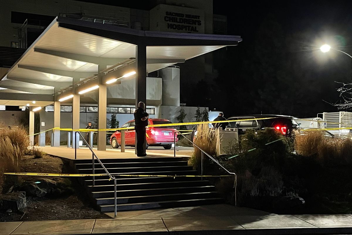 Security officers are shown outside Providence Sacred Heart Medical Center Tuesday after a wounded man briefly engaged in a standoff with officers while a toddler was in his vehicle, media reported.   (Garrett Cabeza/THE SPOKESMAN-REVIEW)