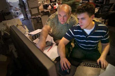 
Hugh Evans works at a computer screen with Dan Davidson of his engineering staff on a product design. 
 (The Spokesman-Review)