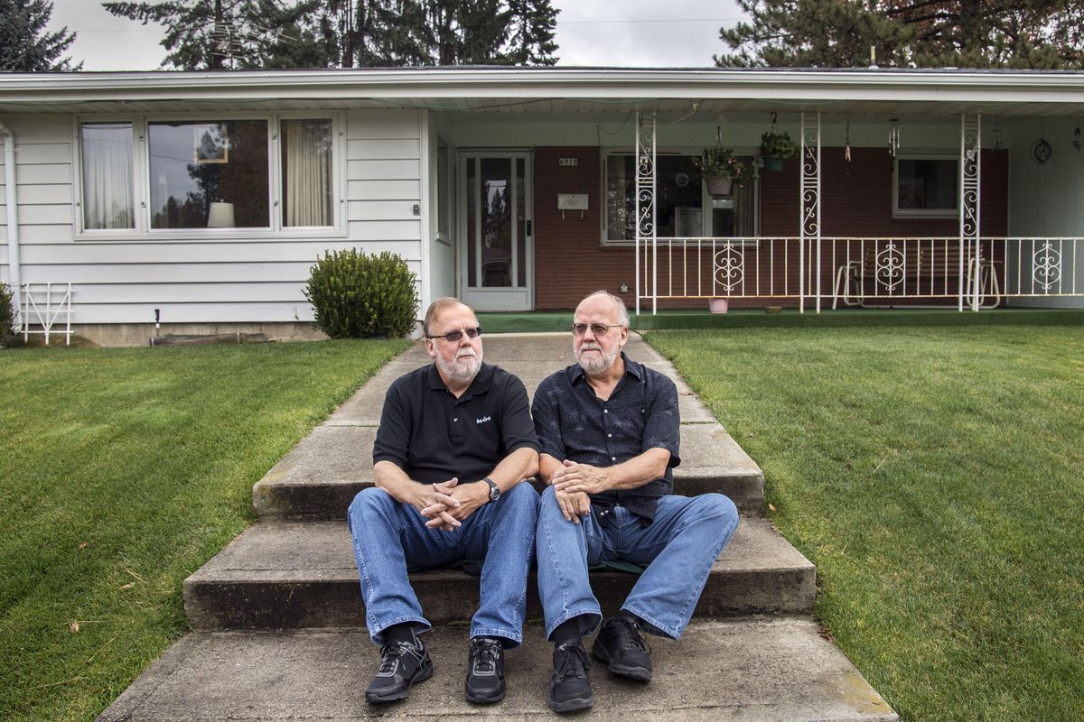 Gary and Larry James sit in front of their childhood home in the South Indian Trail neighborhood, Oct. 28, 2016, in Spokane. The family wants their former home to be converted into housing for elderly veterans who require home care. (Dan Pelle / The Spokesman-Review)