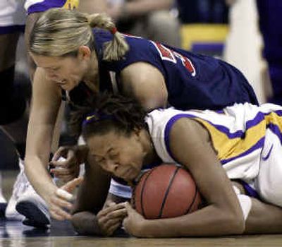 
Liberty's Rima Margeviciute, top, and LSU's Seimone Augustus battle for a loose ball during the first half Saturday.
 (Associated Press / The Spokesman-Review)