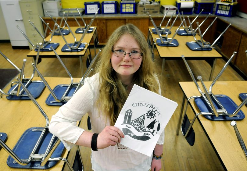 Shaw Middle School seventh-grader Claire Mattes holds the winning manhole cover design she created for a contest sponsored by the city of Spokane.danp@spokesman.com (Dan Pelle)