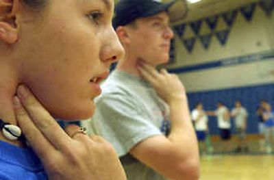 
Coeur d'Alene High School freshmen Sarah Zierer, left and Brad Mitchell check their heart rate during PE class.
 (Kathy Plonka / The Spokesman-Review)