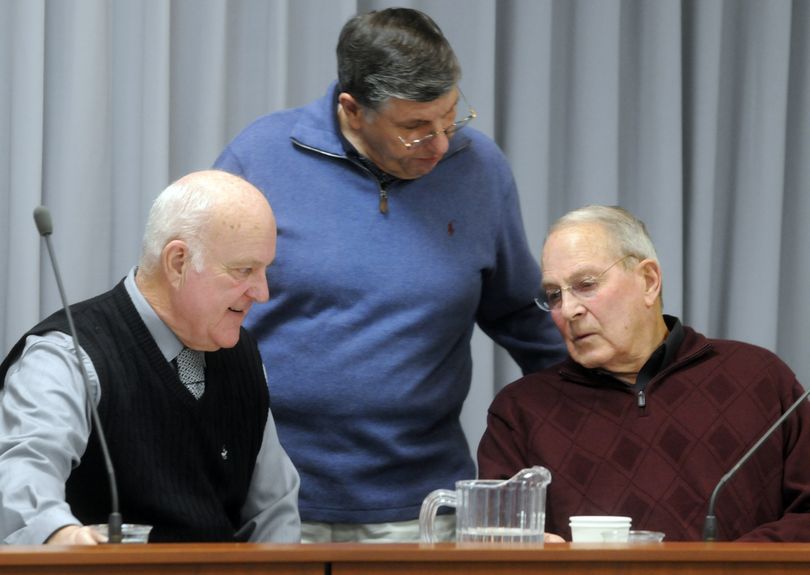  Spokane Valley Mayor Tom Towey, left, chats with city councilmen Dean Grafos, center, and Gary Schimmels before a City Council meeting Dec. 28.
