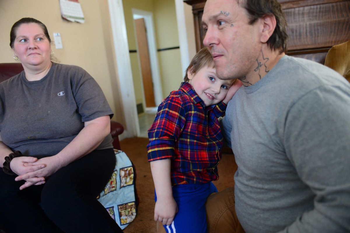 Spokane resident David Cook, right, holding his son Cash, talks about getting his first job out of apprentice training for the carpenters’ union. At left is his partner, Shandrea Martin. Cook began his new job this month in Othello, Washington. (Jesse Tinsley / The Spokesman-Review)