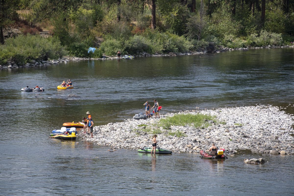 Tubers prepare to leave High Bridge Park, west of downtown Spokane, on a hot day last August. Wear a life jacket when recreating on the area’s rivers and lakes.  (Jesse Tinsley/The Spokesman-Review)