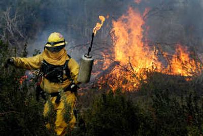 
Madera Mariposa firefighter Mike Gomez moves quickly away from a backfire he set in Holcomb Valley, Calif., on Sunday.Associated Press
 (Associated Press / The Spokesman-Review)