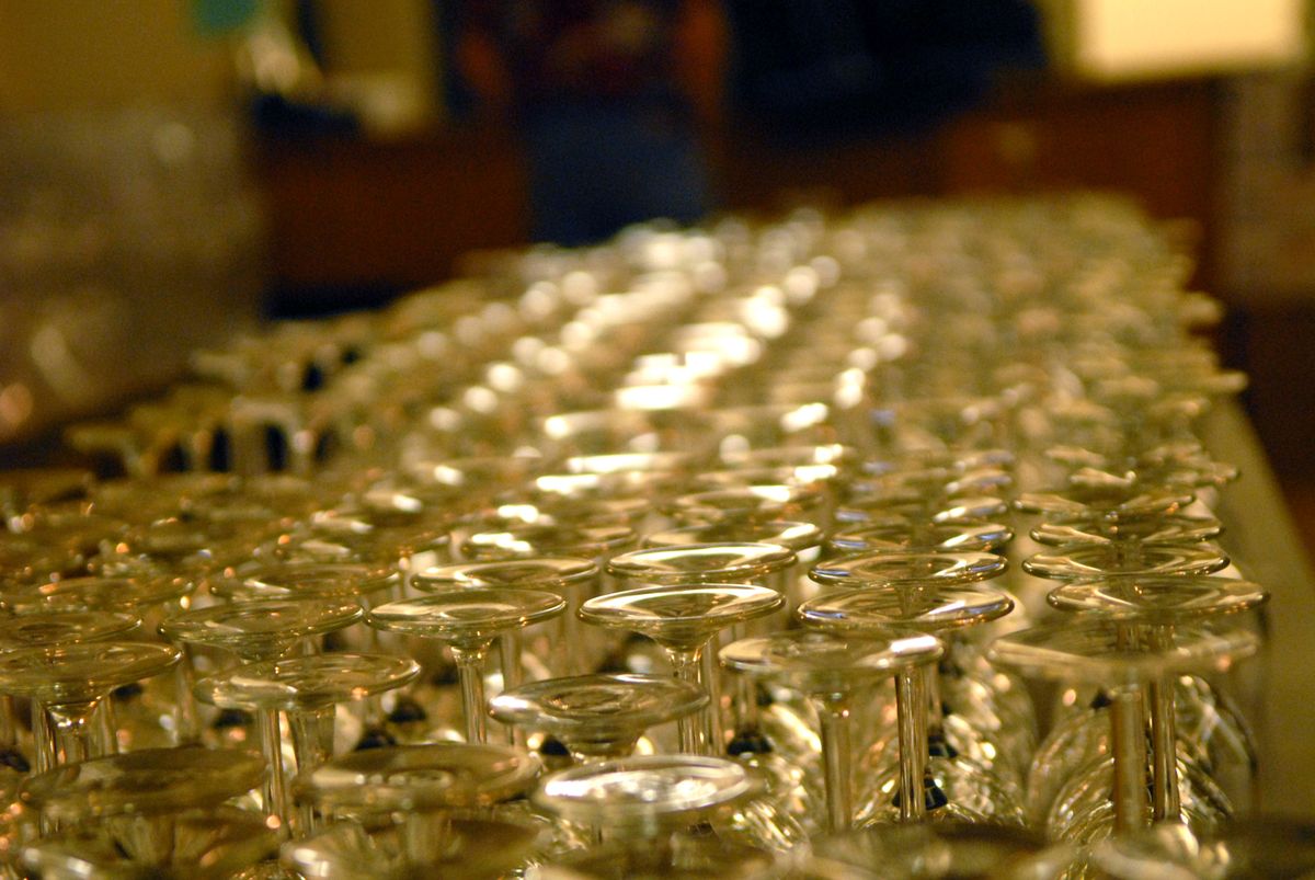 Rows of glasses await bidders Sunday at Ella’s Supper Club. (Brian Plonka / The Spokesman-Review)
