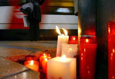 
Candles burn on a train platform Friday, commemorating the victims of the March 11, 2004, train bombings at Madrid's Atocha railway station.
 (Associated Press / The Spokesman-Review)