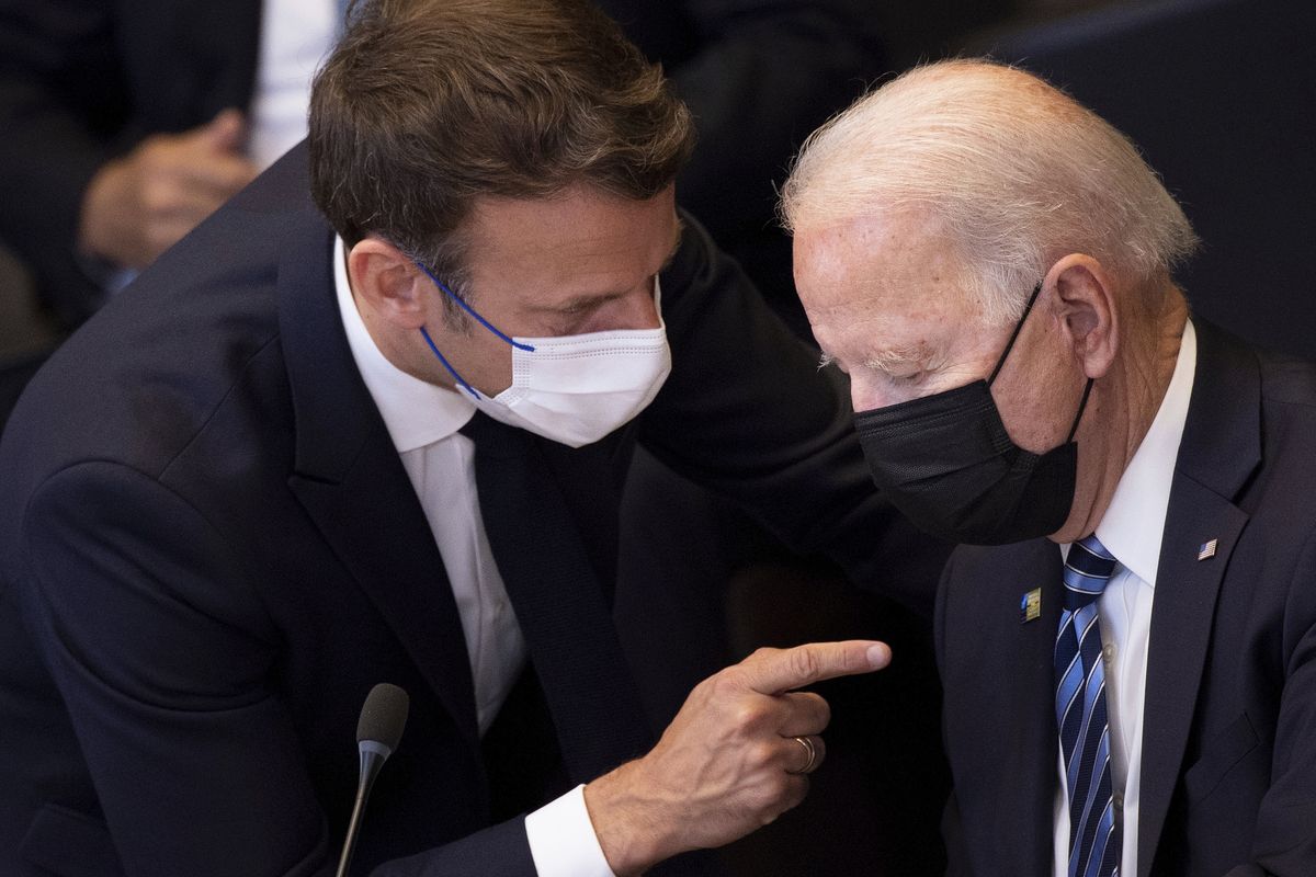 FILE - In this June 14, 2021 file photo, U.S. President Joe Biden, right, speaks with French President Emmanuel Macron during a plenary session during a NATO summit at NATO headquarters in Brussels. French President Emmanuel Macron expects "clarifications and clear commitments" from President Joe Biden in a call to be held later on Wednesday to address the submarines