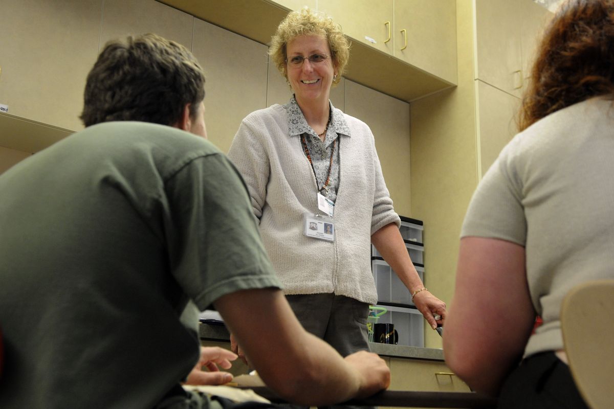 Lewis and Clark High School special-education teacher Jill Nowak helps students with a life-skills exercise Thursday. (Colin Mulvany / The Spokesman-Review)