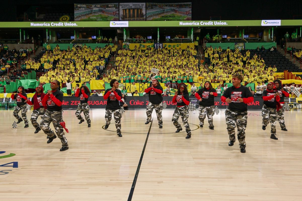 The step team dances in front of the Shadle Park High School section of the Numerica Veterans Arena as part of the rivalry Groovy Shoes game.  (Spokane Public Schools)