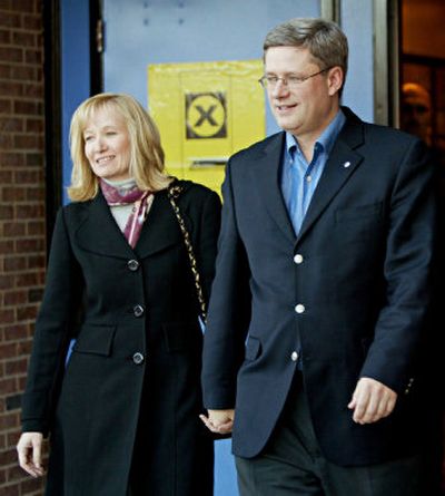 
Canada's Conservative Party Leader Stephen Harper and his wife, Laureen Teskey, leave a polling station after Laureen voted in the federal election in Calgary, Alberta, on Monday. 
 (Associated Press / The Spokesman-Review)
