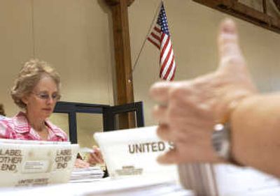 The Spokesman-Review Dori Jordan, from Spokane Valley, begins the ballot sorting process at the Spokane, Wash., elections office Aug. 15. The ballots are sorted down to the precinct level daily but will not be counted until election day.
(Joe Barrentine / The Spokesman-Review)