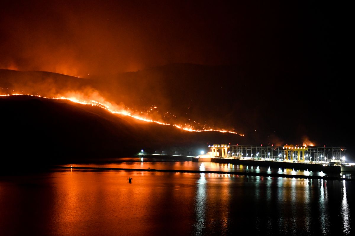 Flames from the Cold Springs Canyon Pearl Hill fire encrouch toward Wells Dam on Monday, September 7, 2020, near Azwell, Wash. Wildfires have knocked out of power in most of north central Washington.  (Tyler Tjomsland/THE SPOKESMAN-REVIEW)