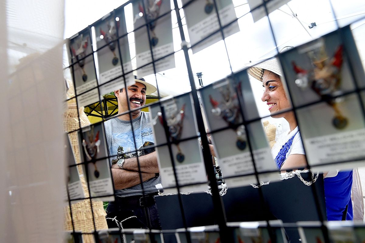 Keith D’Souza, left, helps his wife, Rosita Miranda, choose a pair of earrings from Molly Willson Perry’s porcelain jewelry collection for sale Saturday, June 4, during ArtFest 2016 at Coeur d’Alene Park in Browne’s Addition in Spokane. The festival continues through Sunday. (Kathy Plonka / The Spokesman-Review)