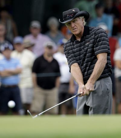 Greg Norman watches his shot to the fifth green Thursday.  (Associated Press / The Spokesman-Review)
