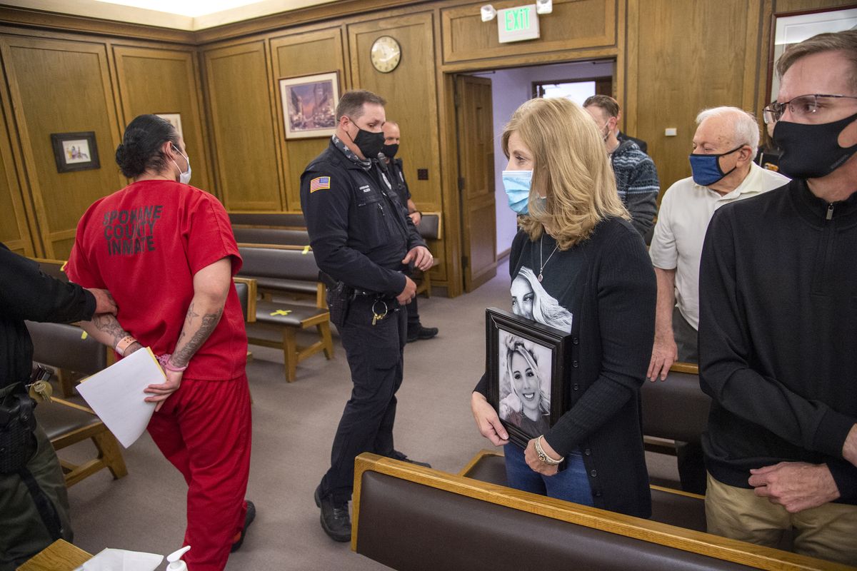 Michael, far right, and wife Christy Young, holding a photo, are pictured in the front row Friday of Judge Maryann Moreno’s courtroom as Anthony Fuerte, left, is led from the room after pleading guilty to first-degree murder for killing their daughter, Makayla Young.  (Jesse Tinsley/THE SPOKESMAN-REVI)