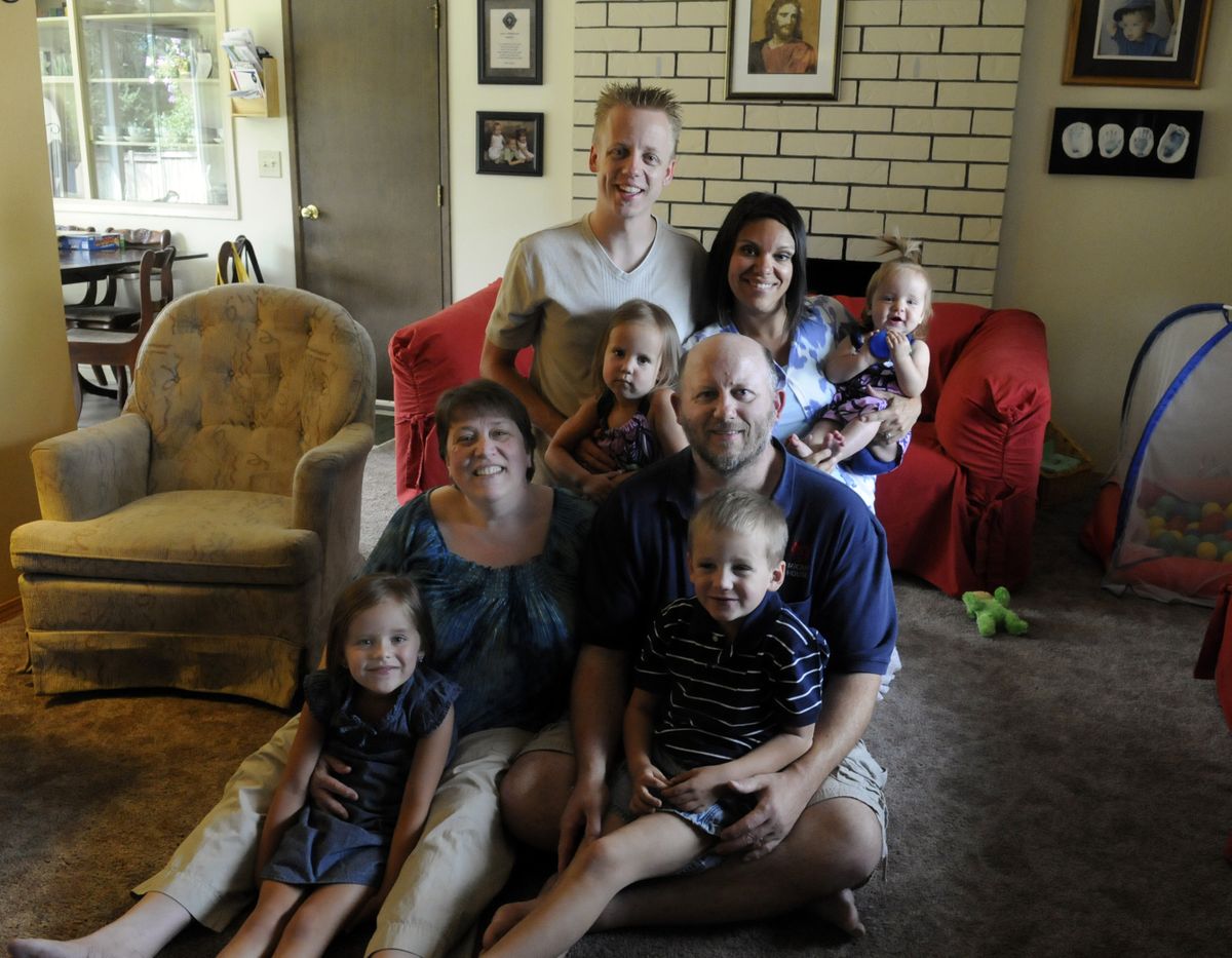 Mary and Dan Shegrud are living in Otis Orchards with her daughter and son-in-law, Jenna and Eric Miller, and their grandchildren, Amelia, 4, (in Mary’s lap); Owen, 6, (in Dan’s lap); Peyton 3, (middle); and 9-month-old Ava. The Shegruds are trying to open Micah House in honor of the Millers’ son Micah, who died after being hit by a car. (J. BART RAYNIAK)