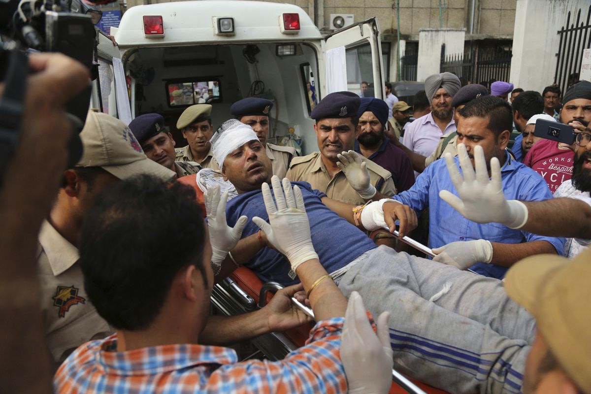 An Indian Hindu pilgrim injured in a bus accident is brought for treatment at a hospital in Jammu, India, Sunday, July 16, 2017. A bus plunged into a 150-foot-deep gorge in the Indian portion of Kashmir on Sunday, killing at least 16 Hindu pilgrims on their way to a cave shrine in the Himalayas. (Channi Anand / Associated Press)