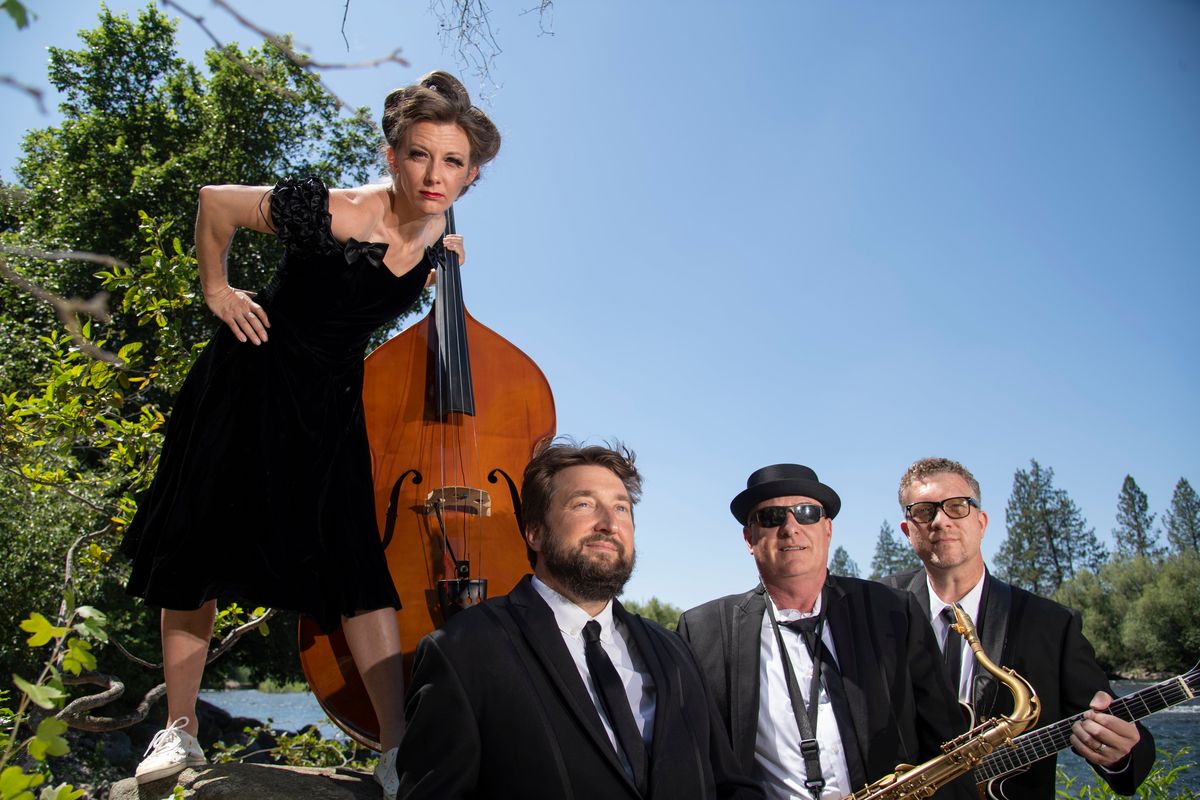 Rockabilly Space Force, photographed July 6, 2020, at High Bridge Park by the Spokane River, is a band made up of Olivia Brownlee on bass and vocals, Andy Bennet (with beard) on drums, Robert Folie on sax and Garrin Hertel on guitar and vocals. It is a newer project of Hertel, who has led Hot Club of Spokane and its newer iteration, the Zonky Jazz Band. (Jesse Tinsley/The Spokesman-Review)
