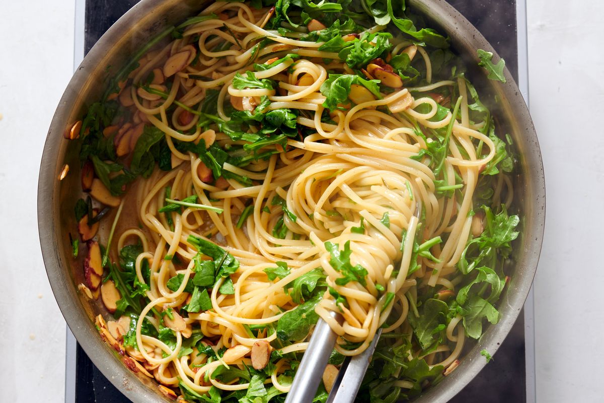 Buttery Lemon Pasta With Almonds and Arugula. Arugula is folded in until it wilts slightly for a peppery bite, but you could also use baby kale or spinach for a milder flavor.  (DAVID MALOSH/New York Times)