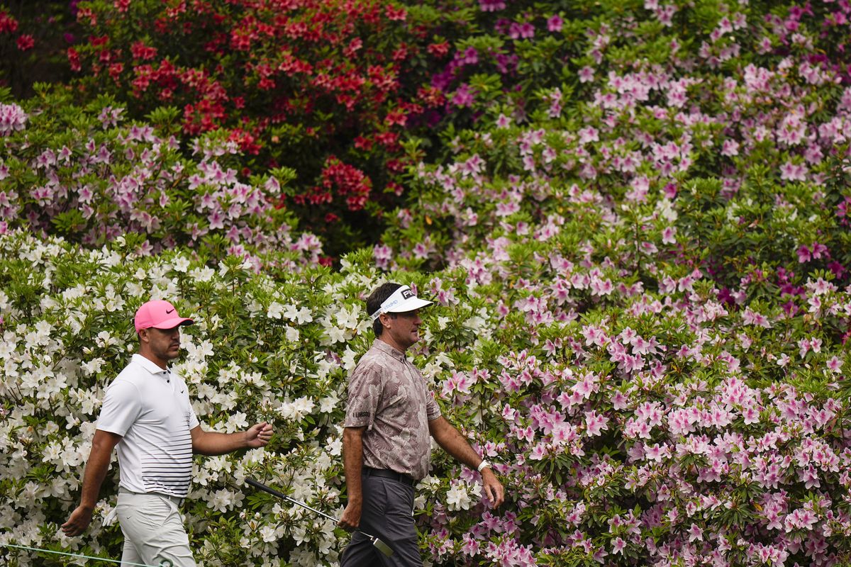 Brooks Koepka and Bubba Watson, right, walk down to the sixth green during the second round of the Masters golf tournament on Friday, April 9, 2021, in Augusta, Ga.  (Associated Press)