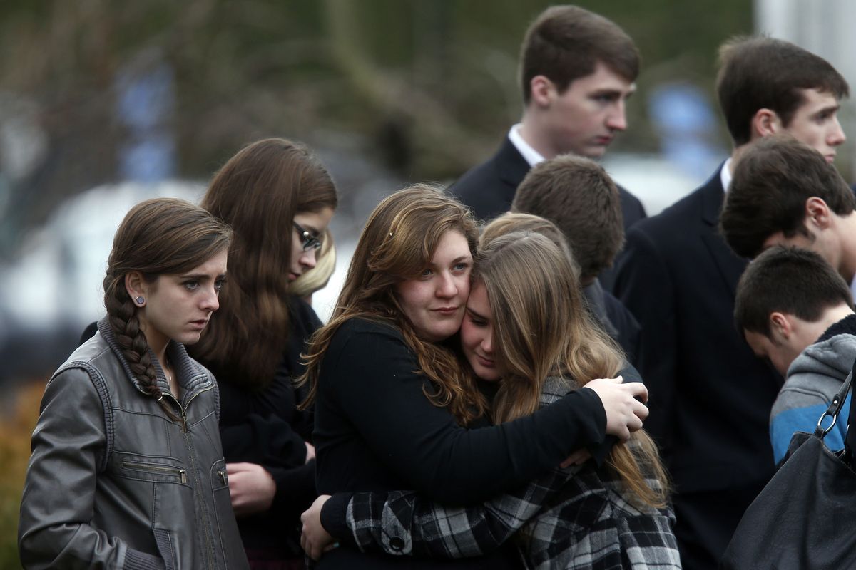 Mourners comfort one another as they leave a funeral service for 6-year-old Noah Pozner, Monday, Dec. 17, 2012, in Fairfield, Conn.  Pozner was killed when a gunman walked into Sandy Hook Elementary School in Newtown Friday and opened fire, killing 26 people, including 20 children. (Jason Decrow / Fr103966 Ap)