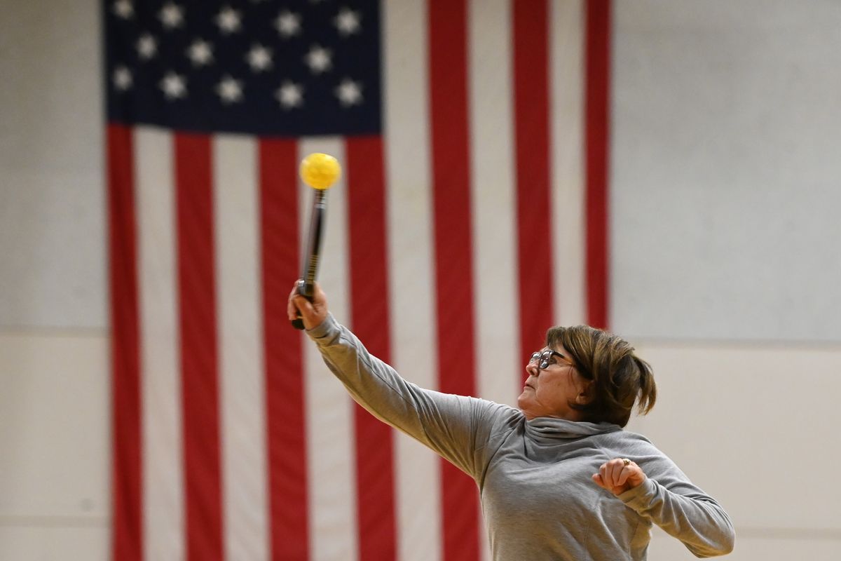 Vicki Currer, 72, leaps as she returns the ball while playing a match of pickleball on Wednesday, Jan 12, 2022, at the Hub in Spokane Valley, Wash.  (Tyler Tjomsland/The Spokesman-Review)