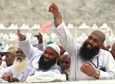 
Pilgrims throw stones at pillars representing the devil in Mina, outside of Mecca, Saudi Arabia, on Saturday. 
 (Associated Press / The Spokesman-Review)