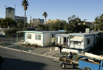 
Workers remove furniture from a mobile home at the shuttered Tropicana Mobile Home park in Las Vegas last month.
 (Associated Press / The Spokesman-Review)