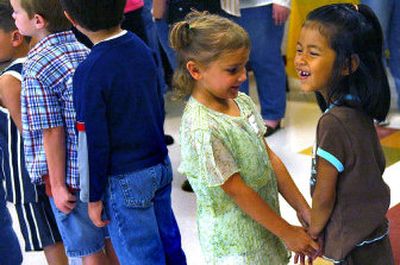 
Nuanna Frahm, far right,  and Makayla Judd make their way through their first day of kindergarten Tuesday at Ramsey Elementary in Coeur d'Alene. . 
 (Kathy Plonka / The Spokesman-Review)