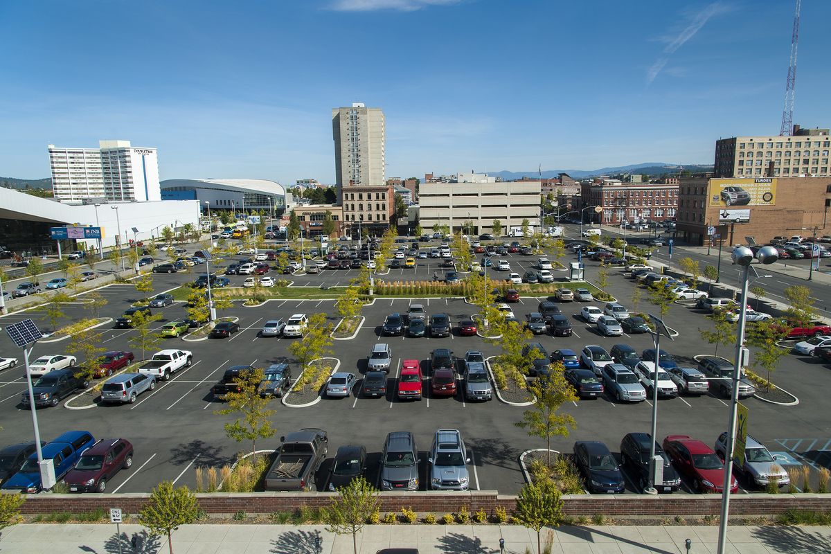 Davenport Hotel owners Walt and Karen Worthy on Wednesday announced their intentions to build a 700-room, 15-story hotel on property that encompasses this parking lot just south of the INB Performing Arts Center in downtown Spokane. A skywalk would connect the Convention Center to the hotel. In this view looking east, Spokane Falls Boulevard is to the left and Main Avenue is to the right. (Colin Mulvany)