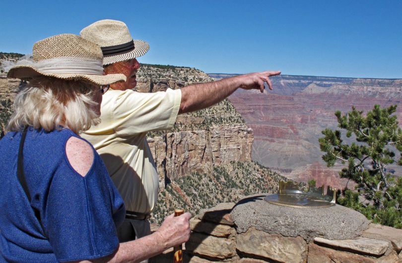 Karen and Tom Jacobs, of Carrollton, Texas, look out over the South Rim of the Grand Canyon on Tuesday, Sept. 30, 2013. National parks would close Tuesday if an agreement is not reached on the federal budget. (Felicia Fonseca / Associated Press)