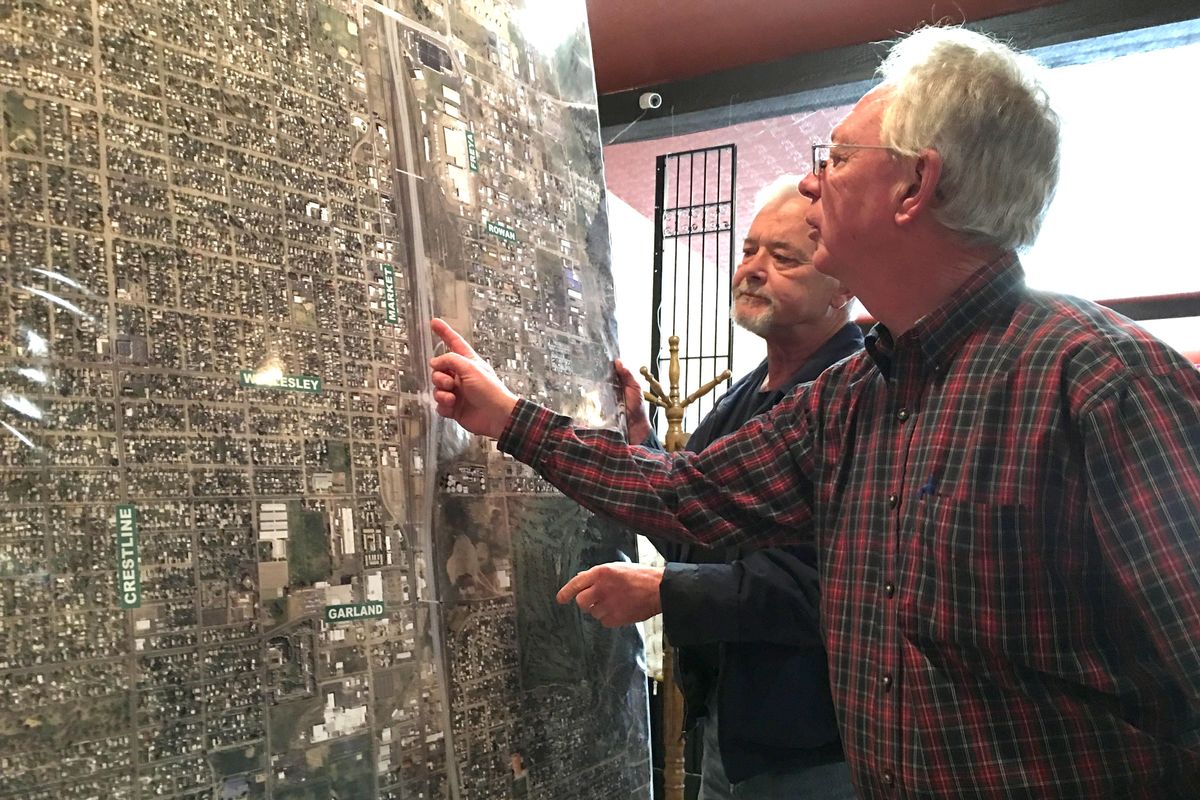 David Griswold, left, and Richard Burris talk about ideas for the route of the north-south freeway corridor through Hillyard. (Jesse Tinsley / The Spokesman-Review)