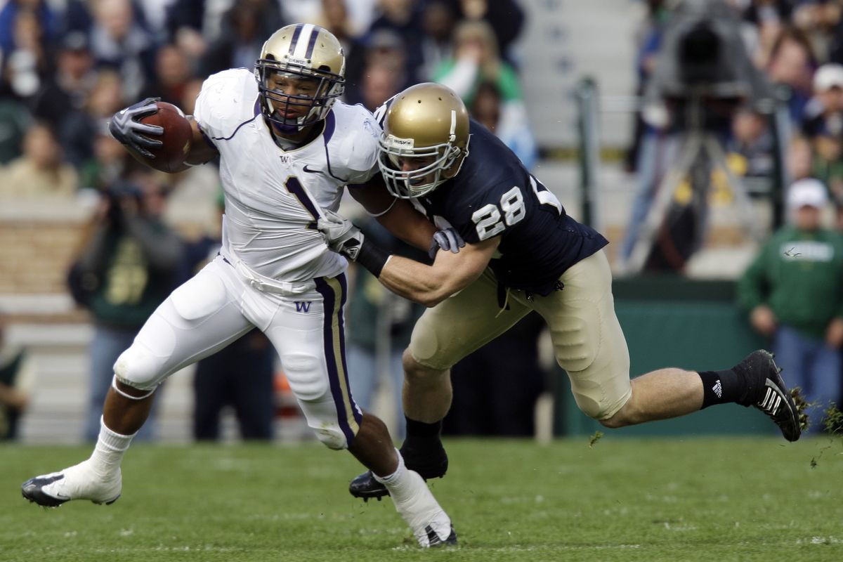 Notre Dame safety Kyle McCarthy drags down Washington running back Chris Polk in the first quarter. (Associated Press / The Spokesman-Review)