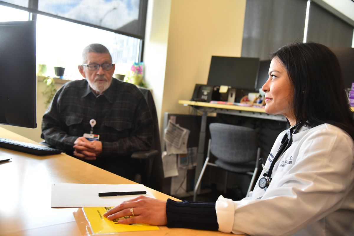 Dr. Paul Russell confers with Dr. Mara Hazeltine, a Family Medicine Residency Spokane resident at the Spokane Teaching Health Clinic in Spokane, on April 15. Russell has been mentoring younger doctors through the residency program since the 1970s.  (Jesse Tinsley/The Spokesman-Review)