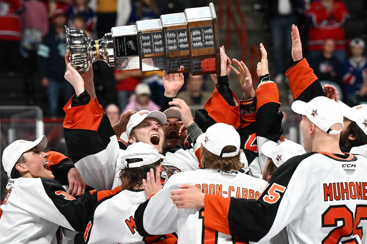 Medicine Hat Tigers goaltender Harrison Meneghin (35) hoists the Ed Chynoweth Cup after winning the WHL Championship Series during the third period in Game 5 of the Western Hockey League Championship against the Spokane Chiefs on Friday, May. 16, 2025, at Spokane Arena in Spokane, Wash. Medicine Hat won the game 4-2. (Tyler Tjomsland/The Spokesman-Review)