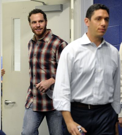 Texas general manager Jon Daniels, right, could use Josh Hamilton’s help right now. (Associated Press)