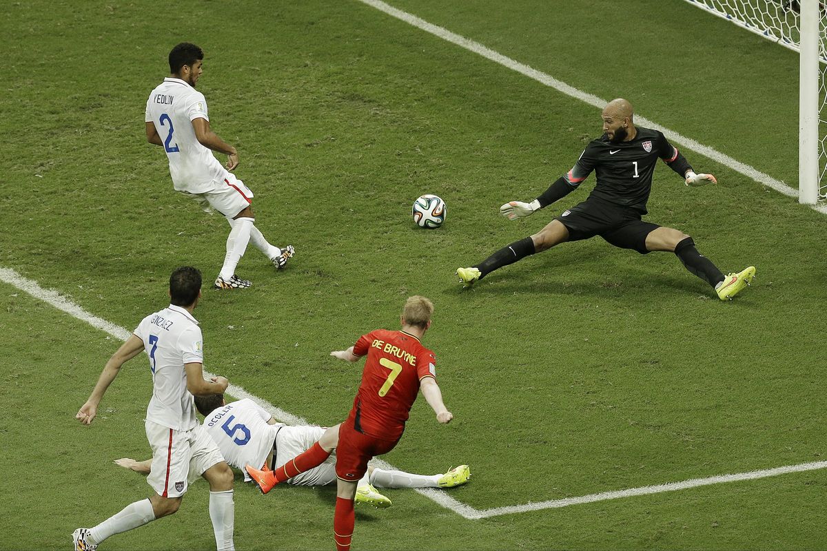 Belgium’s Kevin De Bruyne, center, scores the first goal past USA keeper Tim Howard, right, during a loser-out World Cup soccer match Tuesday in Salvador, Brazil. (Associated Press)