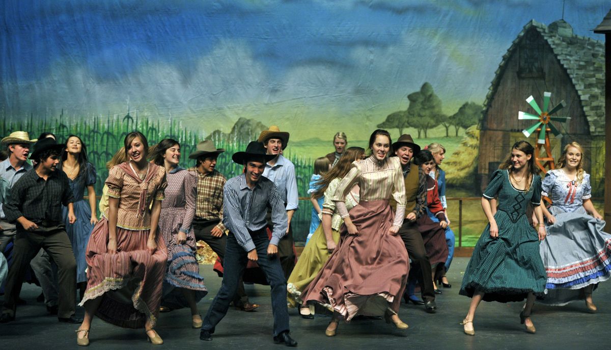 Members of the cast of University High School’s production of “Oklahoma!” perform the opening number during dress rehearsal at the school on Wednesday.  (Dan Pelle)