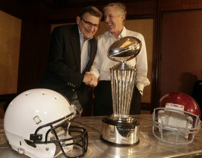 Penn State coach Joe Paterno, left, and USC coach Pete Carroll admire the Rose Bowl’s  trophy.  (Associated Press / The Spokesman-Review)