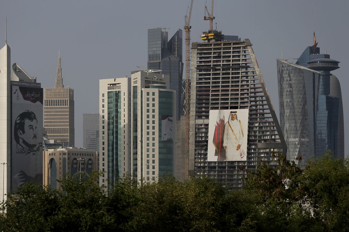 FILE - In this May 5, 2018, file photo, the images of the Emir of Qatar, Sheikh Tamim bin Hamad Al Thani hang on the towers in Doha, Qatar. Qataris awoke to a surprise blockade and boycott by Gulf Arab neighbors 3 1/2 years ago, and this week were jolted again by the sudden announcement that it was all over. (Kamran Jebreili)