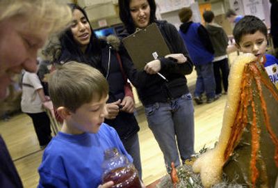 
Eight-year-old Isaac Martin, center, watches his homemade volcano erupt with his mom, Janene Martin, far left, and Lewis and Clark High School judges Julia Kunkel and Teri Lorimor at Roosevelt Elementary School on Thursday afternoon. 
 (Holly Pickett / The Spokesman-Review)